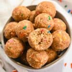 close up of birthday cake protein balls in a white bowl.