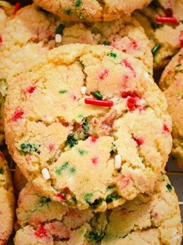 close up shot of one sugar cookie with christmas sprinkles.