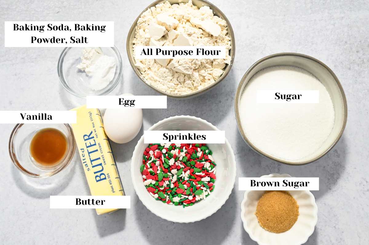 labeled ingredients for making sugar cookies with Christmas sprinkles.