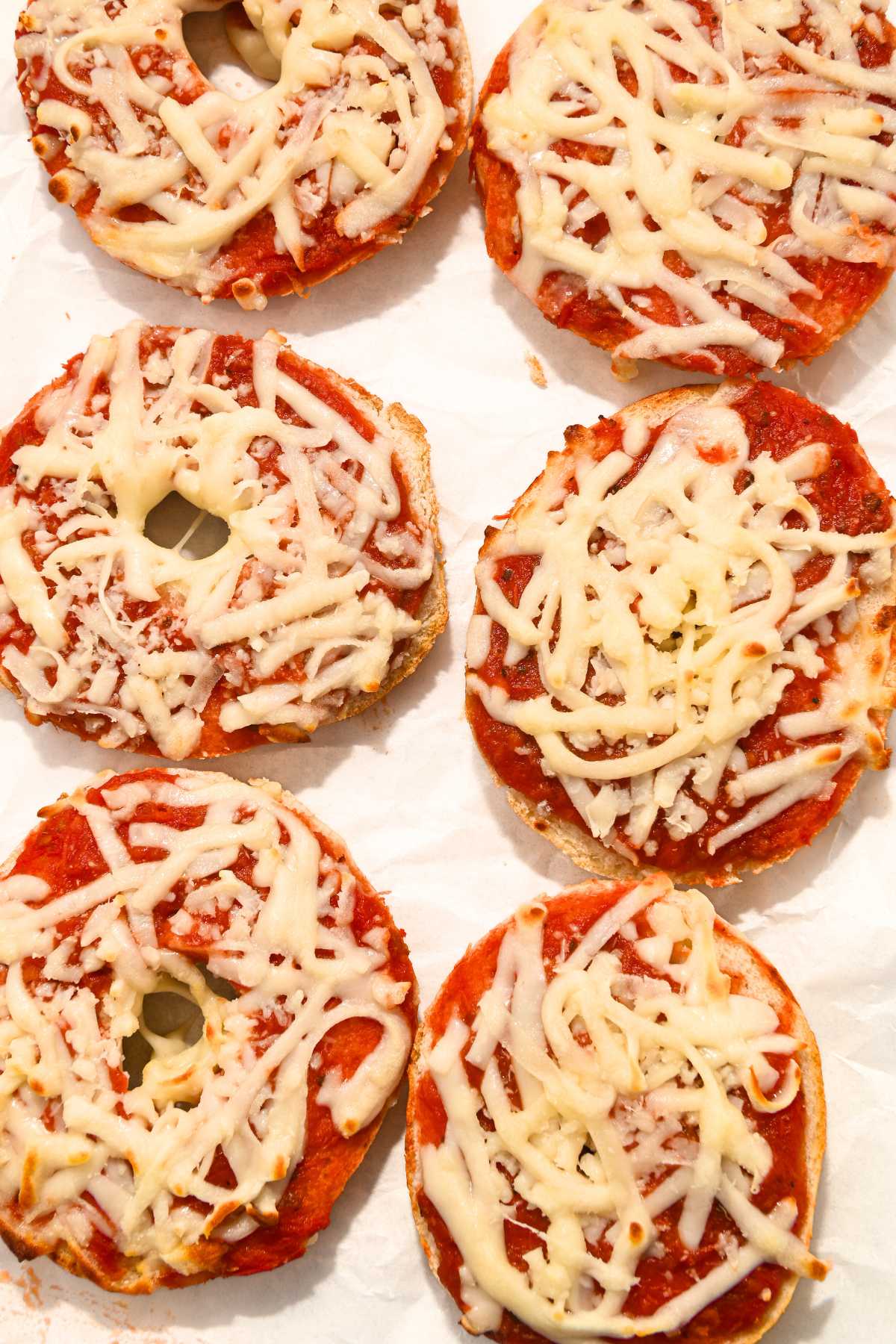 rows of bagel bites on white parchment paper.