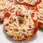close up of air fryer bagel bites on a white background.