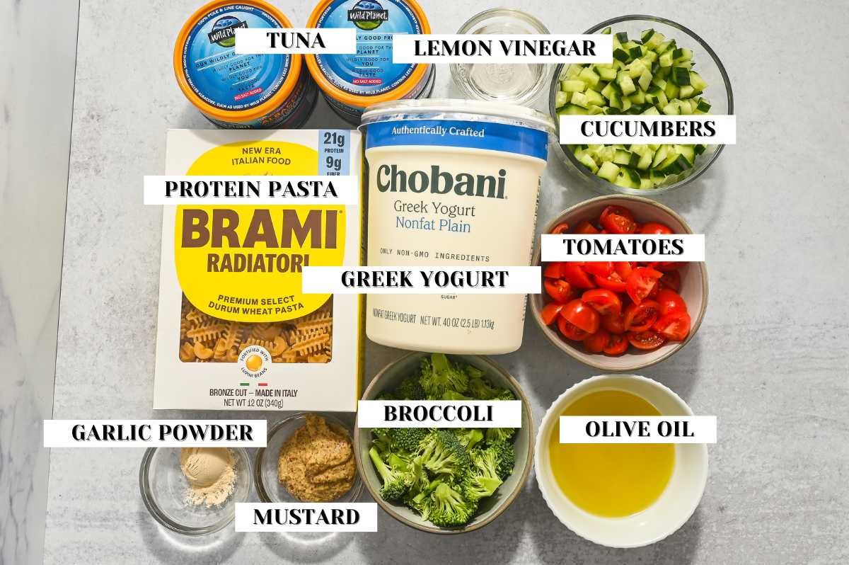 labeled ingredients for no mayo tuna pasta salad on a gray background.