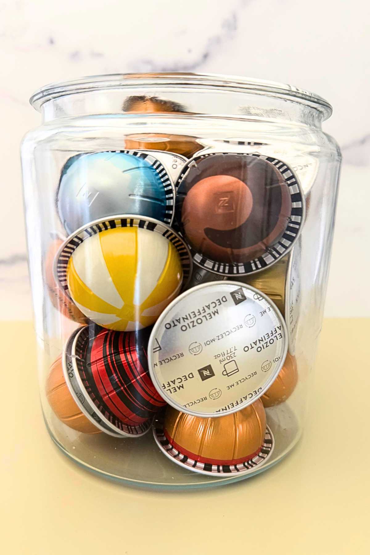 nespresso capsules in a glass jar.