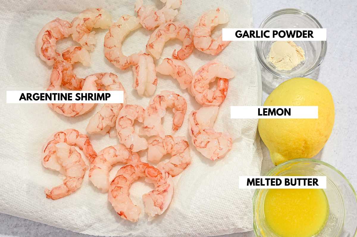 labeled ingredients for blackstone shrimp showing Argentine shrimp, garlic powder, lemon, and melted butter.