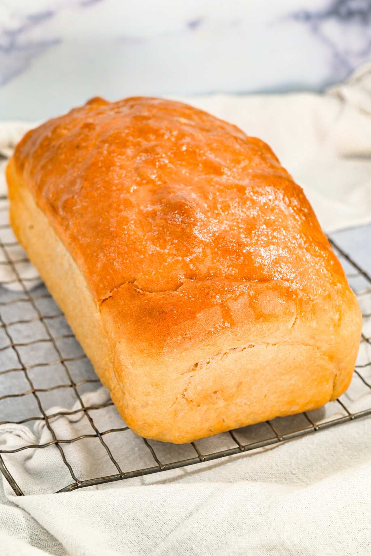 loaf of soft sandwich bread on a cooling rack.