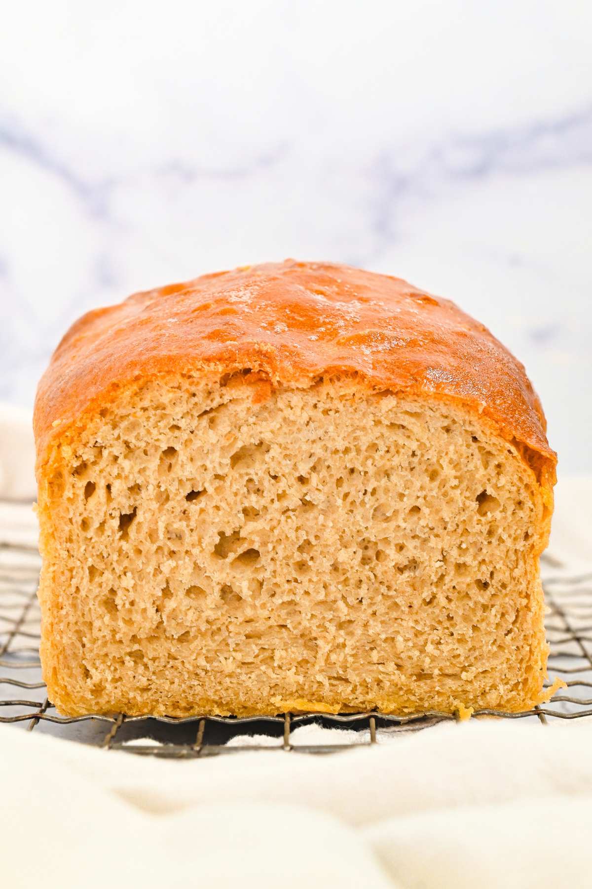 open side of soft sandwich bread on a cooling rack.