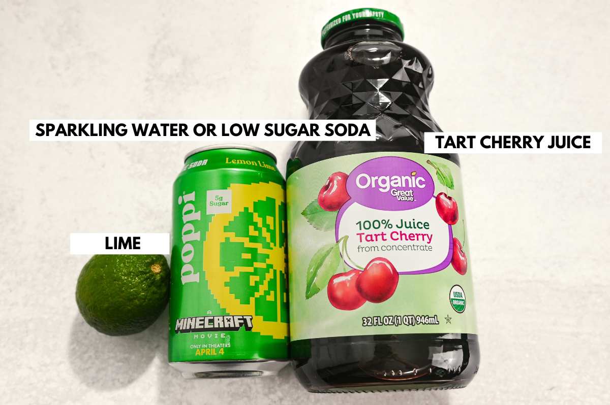 labeled ingredients for making a tart cherry juice mocktail with lemon lime poppi on a white background.