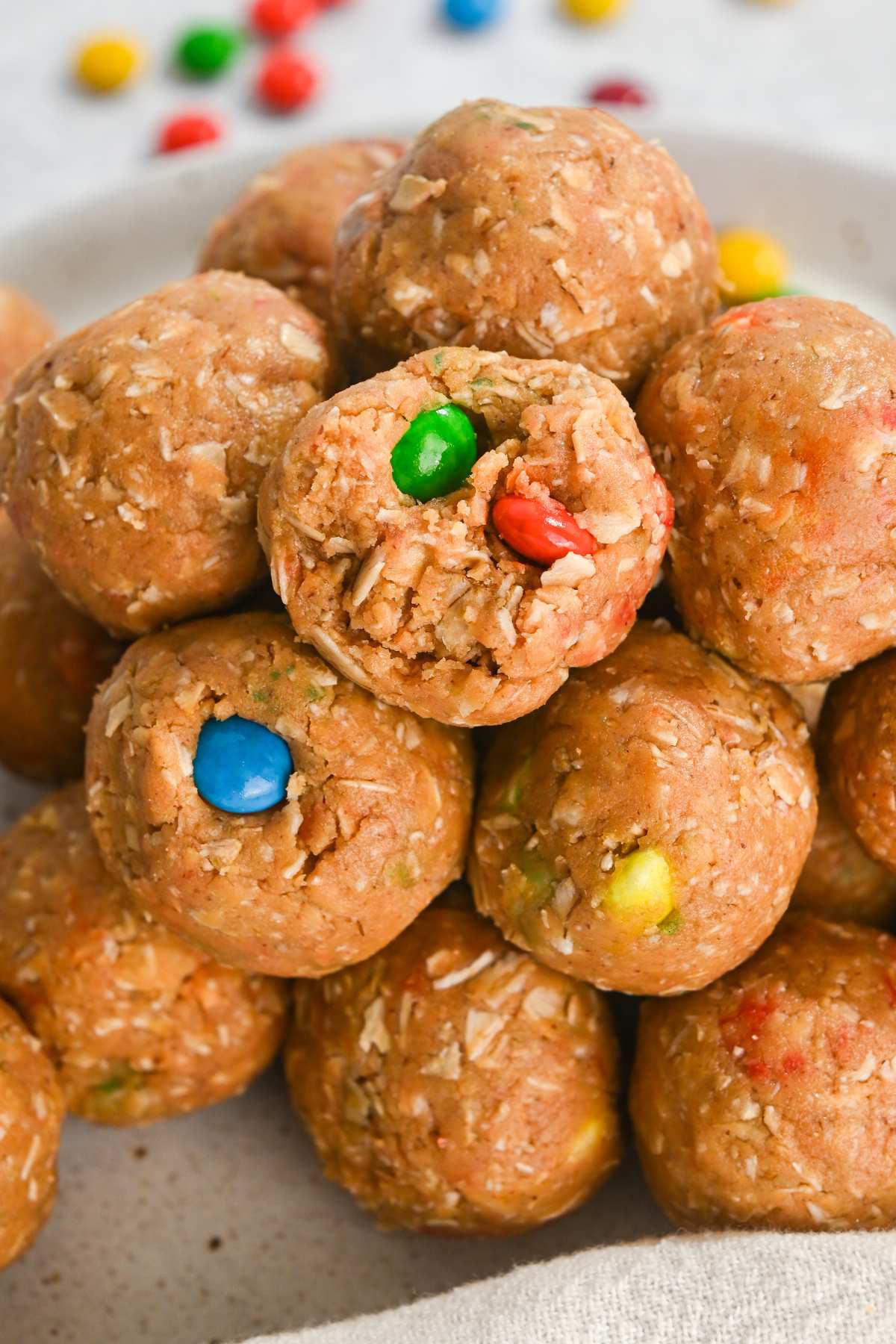 close up of monster protein balls in a stack with a bite taken out of one.