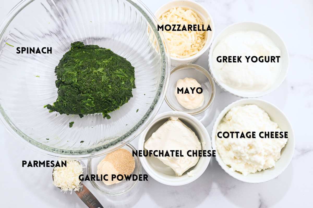 labeled ingredients for making high-protein spinach dip in a flat lay photo.