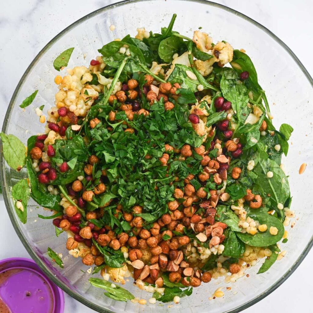 cauliflower salad ingredients in a glass bowl.