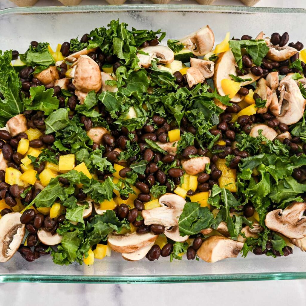 veggie egg casserole bake ingredients in a glass dish.