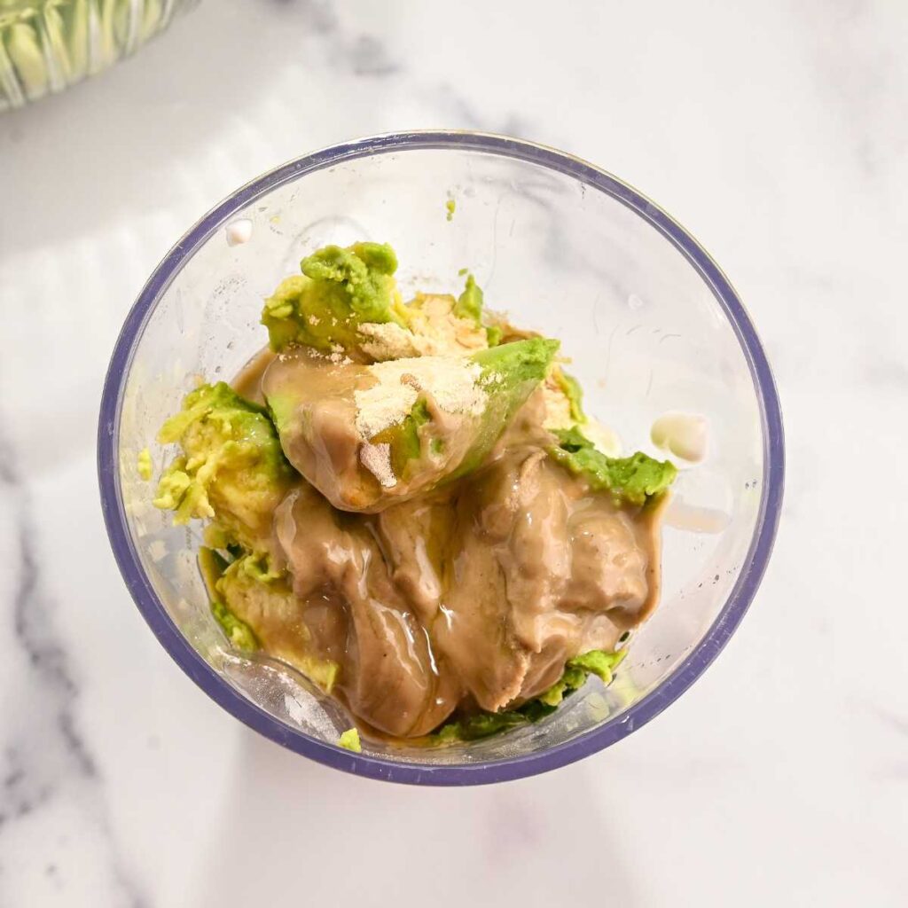 green goddess salad dressing ingredients in a blender cup.