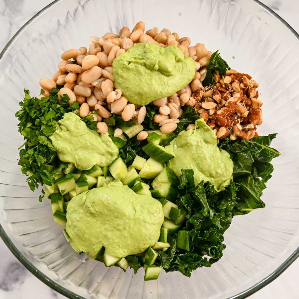 green goddess dressing on top of salad ingredients.