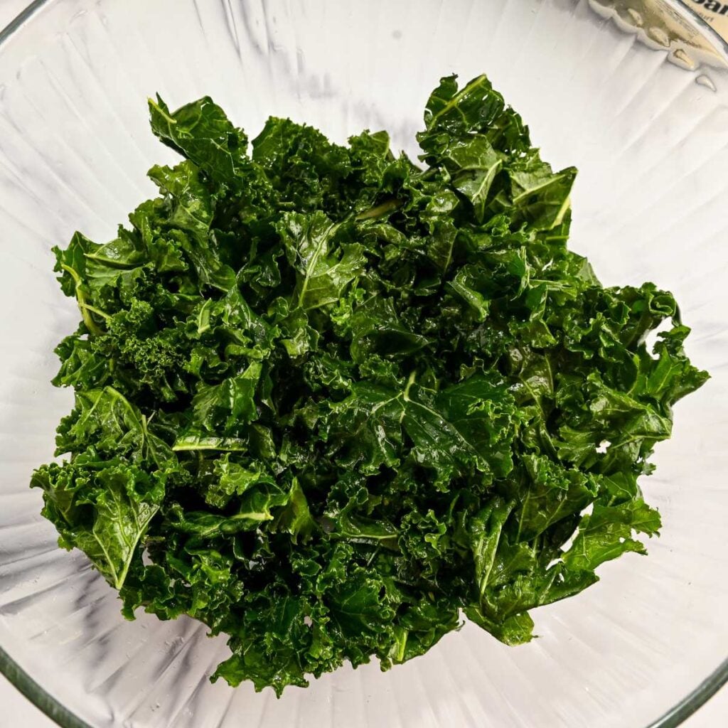 massaged kale in a glass bowl.