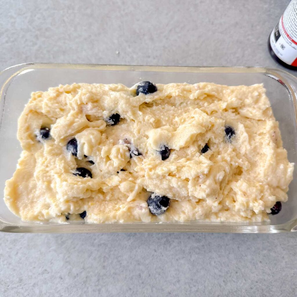 greek yogurt lemon blueberry cake batter in a bread pan.