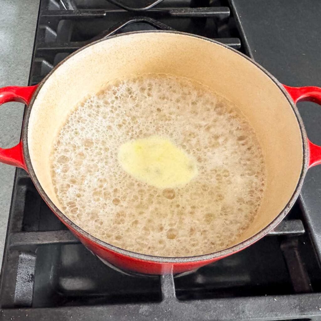 cooking orzo in a pan on the stove.