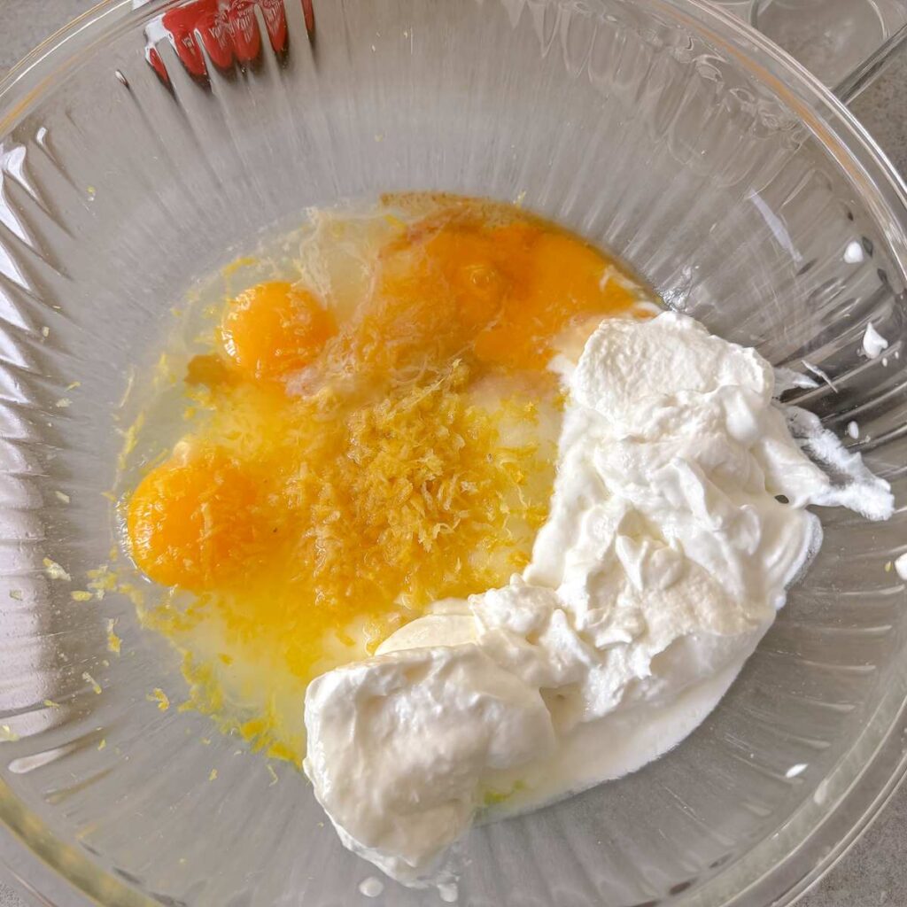 blueberry lemon cake wet ingredients in a glass bowl.