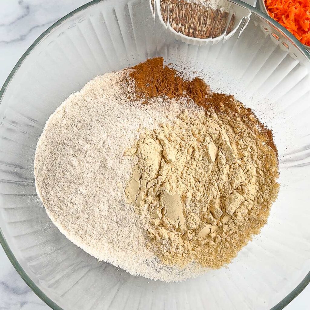 carrot cake protein muffins dry ingredients in a glass bowl.