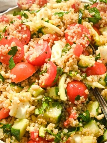 close up square image on italian caprese quinoa salad wtih tomatoes, mozzarella, and basil.