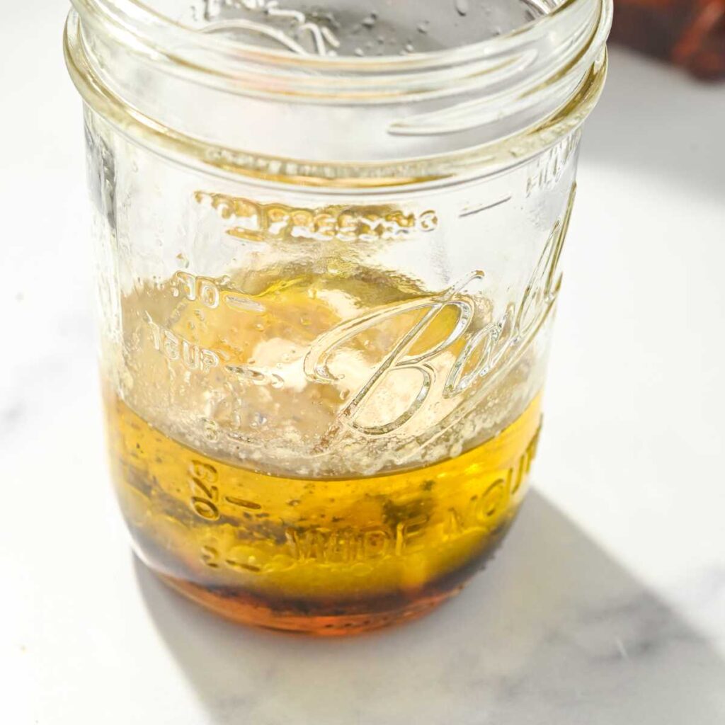 lemon balsamic vinaigrette ingredients in a glass jar.