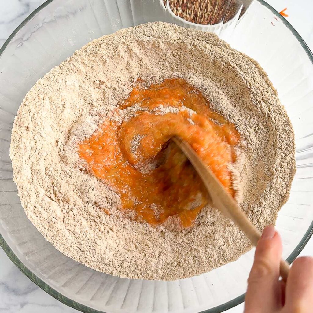 wet muffin ingredients being mixed into the wet ingredients.